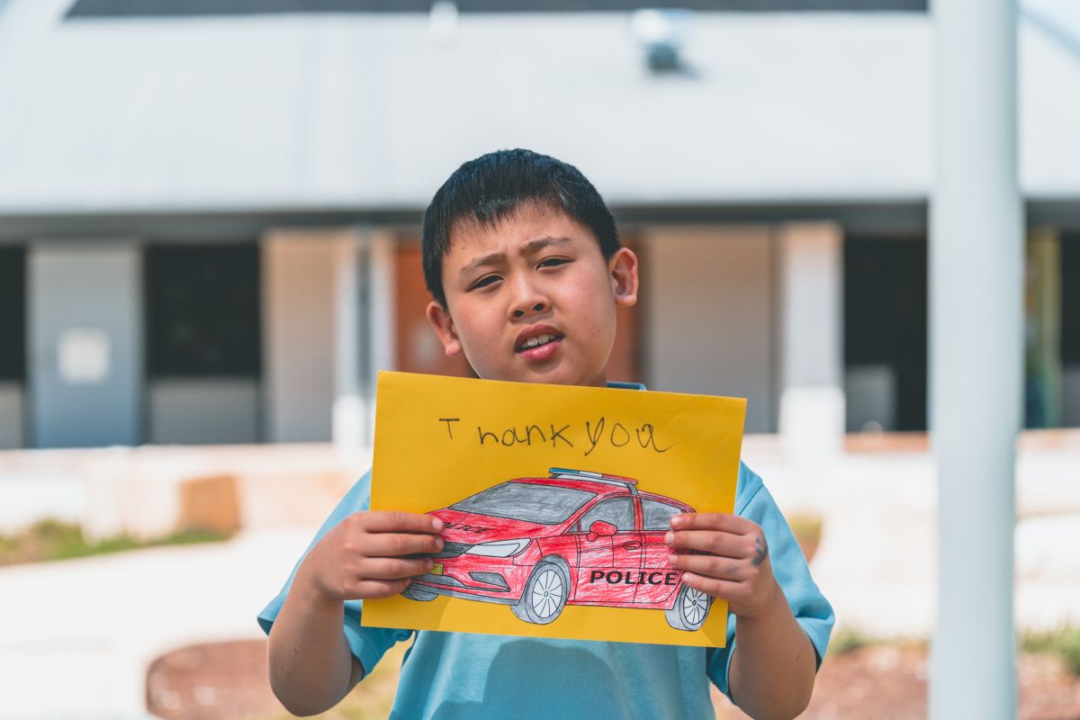 Student with a thank you sign for our supporters