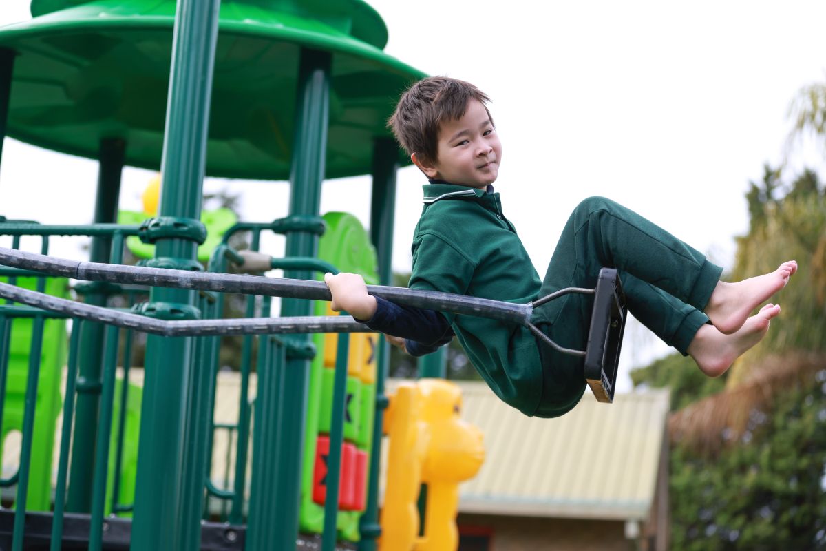 Student using the swing in the playground
