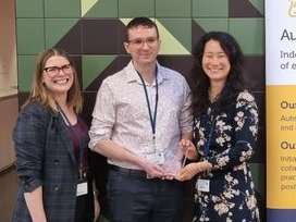 Ru Ying Cai and Chris Edwards receive Autism CRC award from Cheryl Mangan